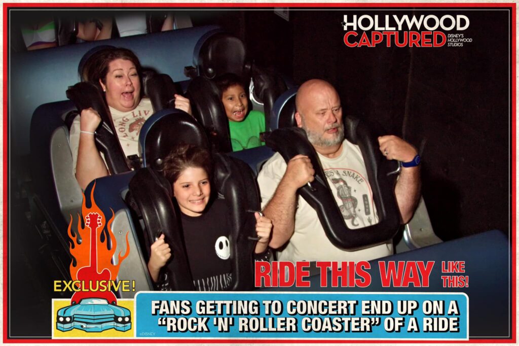 Several riders on a roller coaster making scared faces.